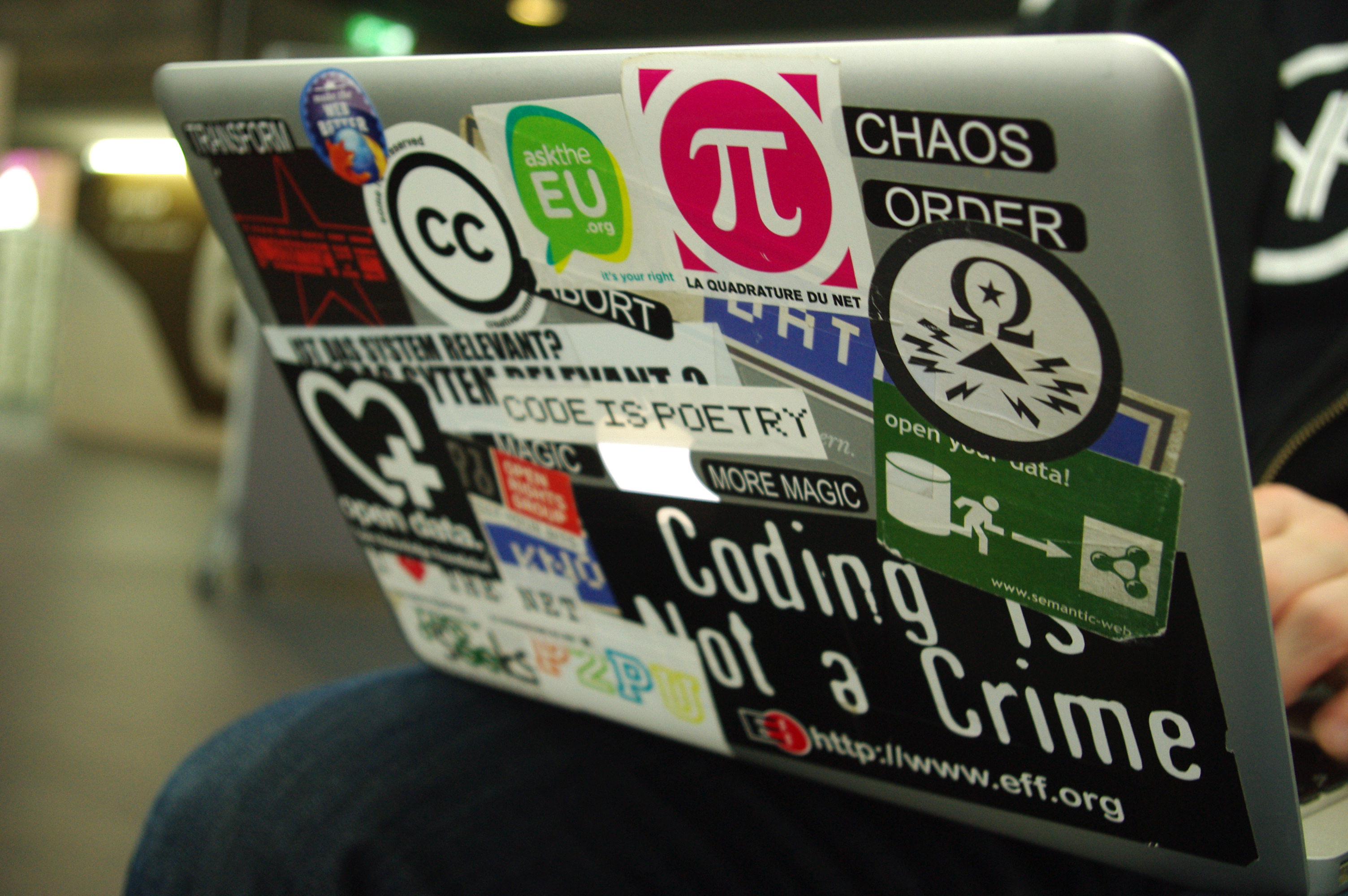 A laptop with different developer stickers on it